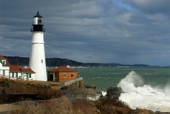 Sunlight Breaks Through Clouds on Lighthouse with Huge Waves